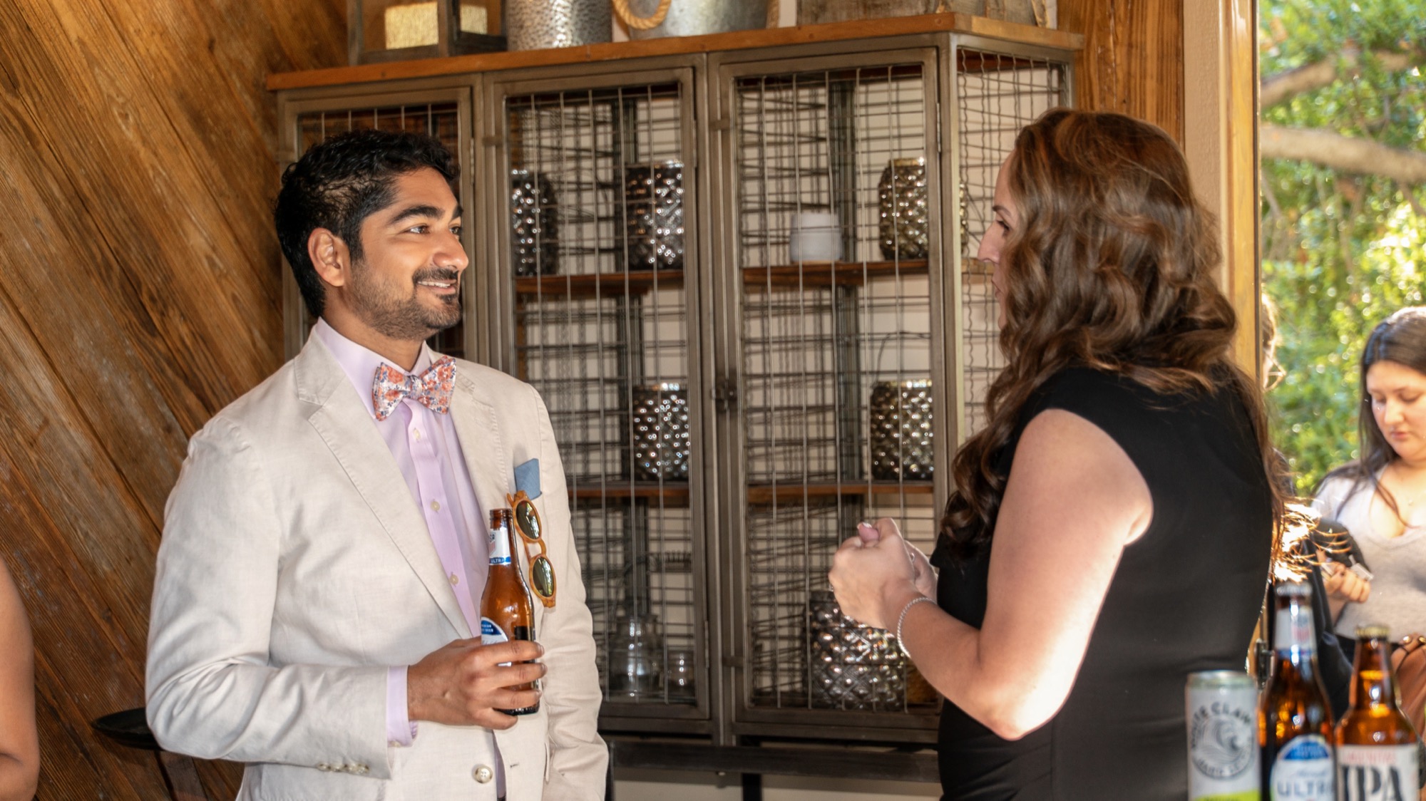 Dr. Amin's husband in conversation with a guest during cocktail hour