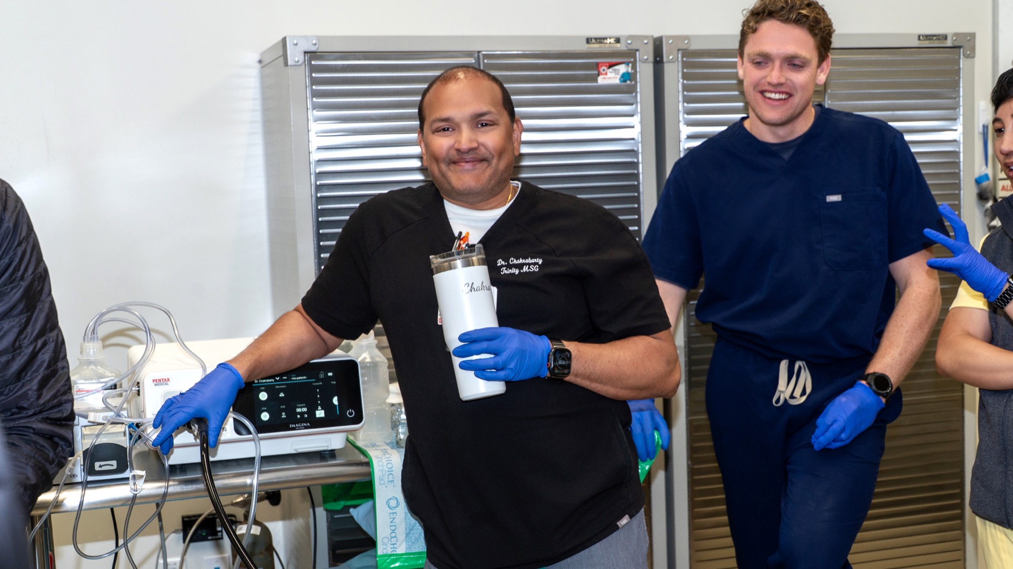 Dr. Chakrabarty and a fellow smiling in the endoscopy suite between training reps