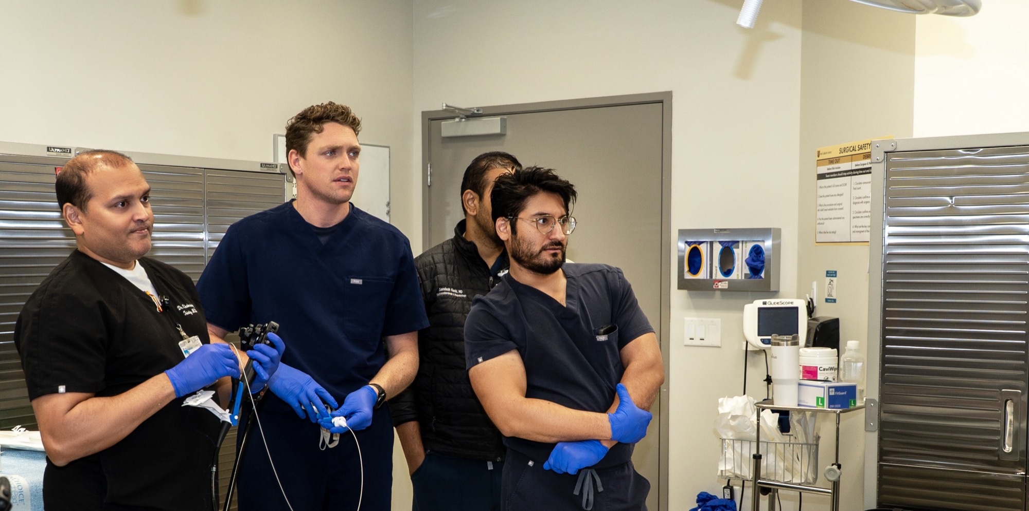 Dr. Chakrabarty, Dr. Trevor Dunbar, Dr. Sandesh Karki, and a fellow watching a demonstration on the monitor
