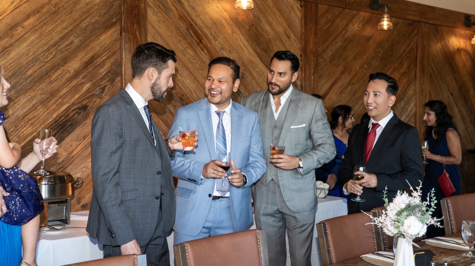 Group of physicians sharing a laugh over cocktails