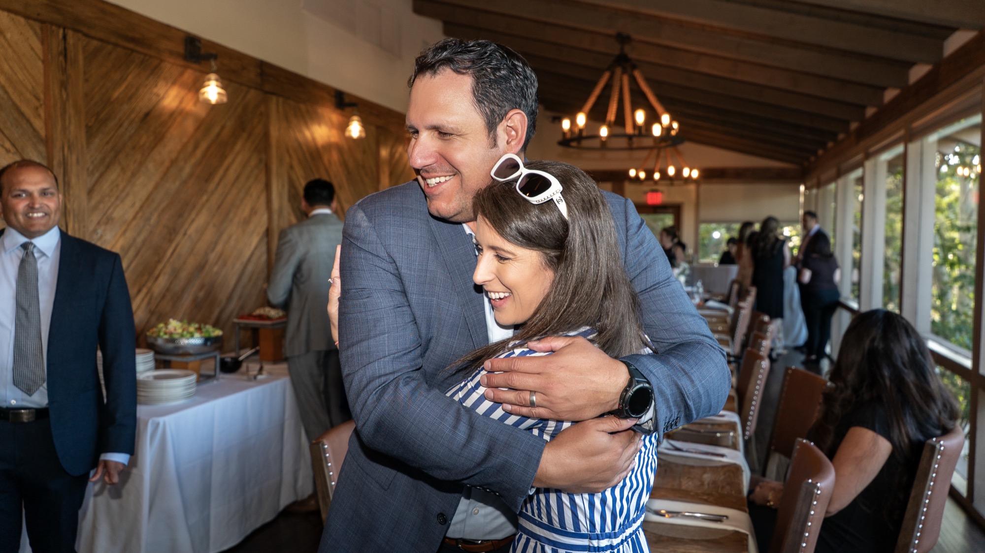 Warm hug shared between guests during the reception