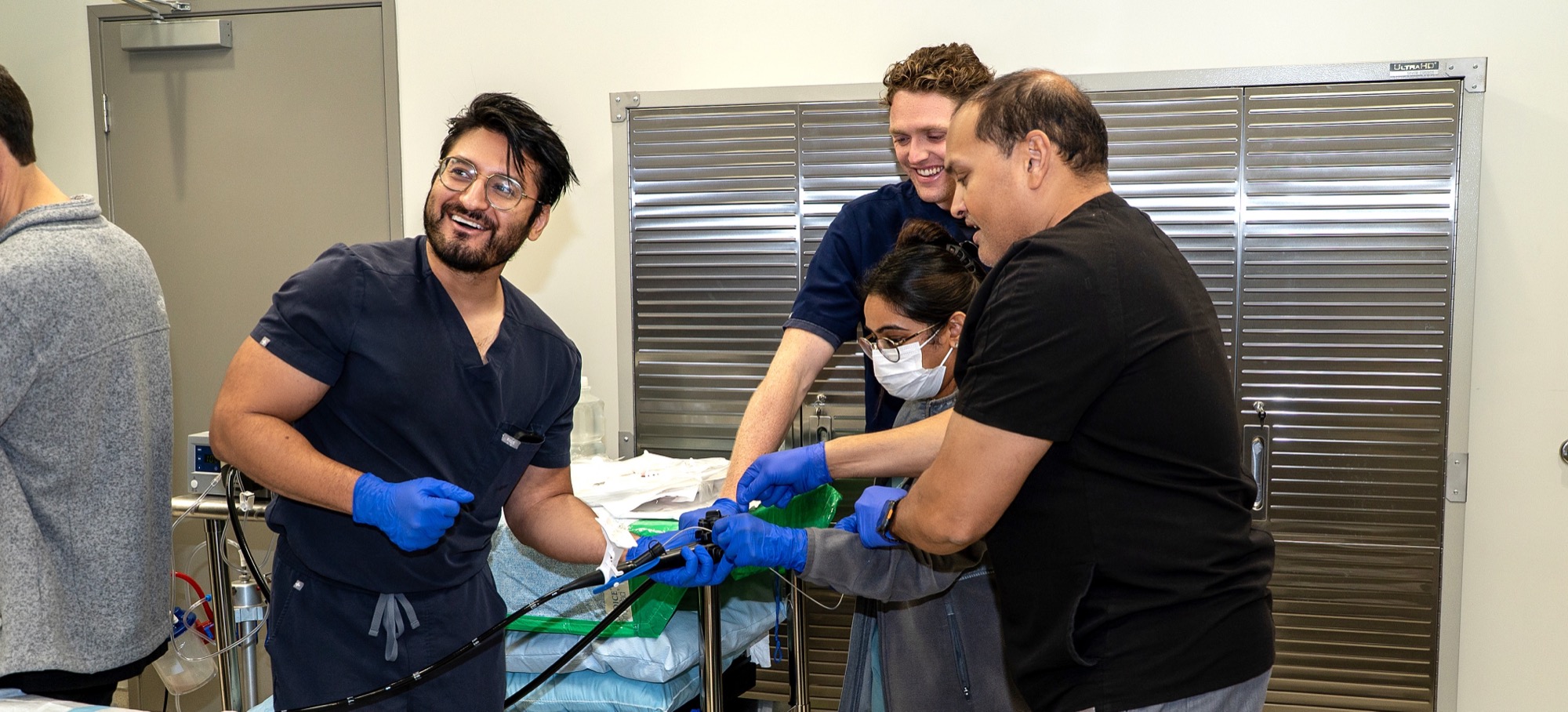 Fellows and Dr. Chakrabarty sharing a laugh while working the scope together