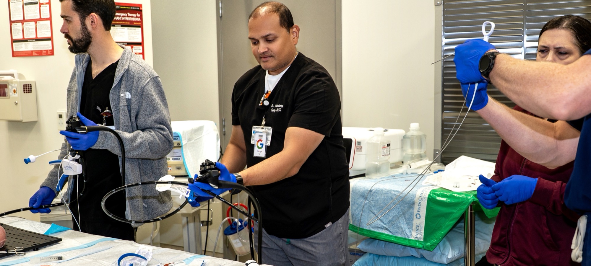 Dr. Trevor Dunbar, Dr. Chakrabarty, and a colleague working with the scope and accessory tools