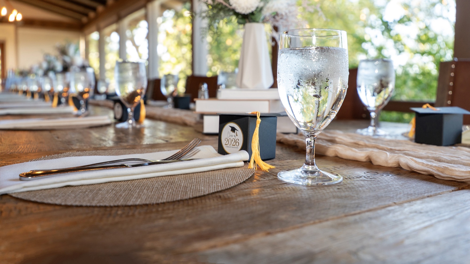 Class of 2026 table setting with graduation cap favors and tassels