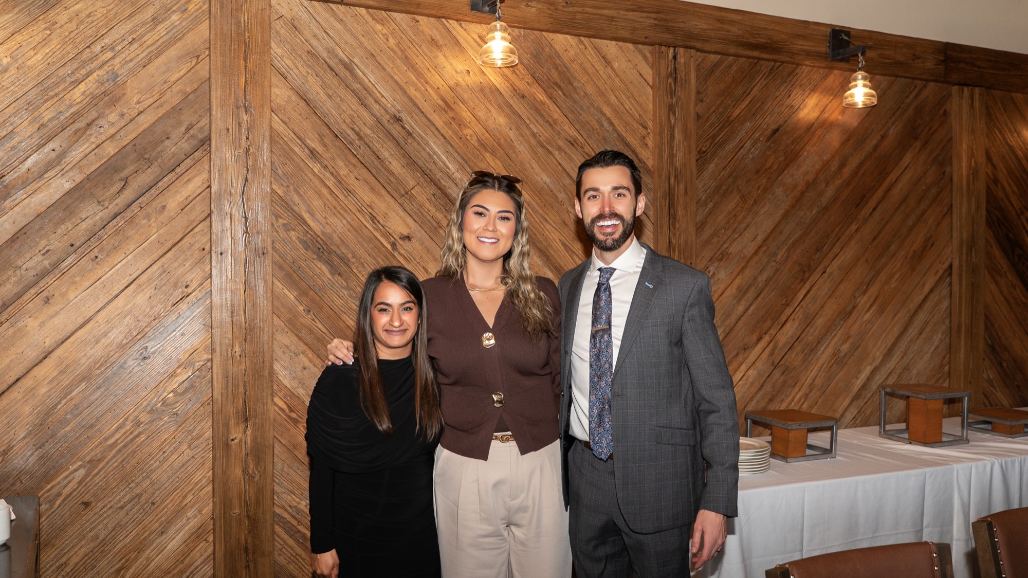 Dr. Amin with two colleagues posing together at the reception