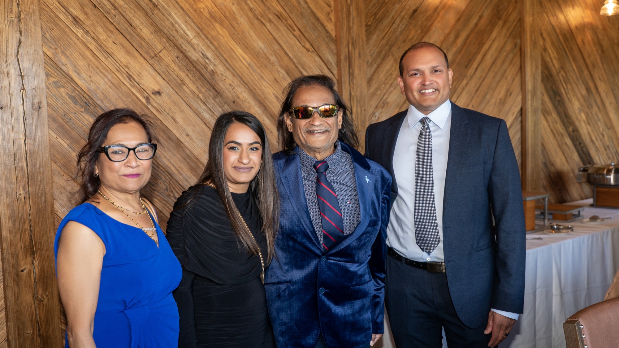 Dr. Amin with her family posing together at the celebration