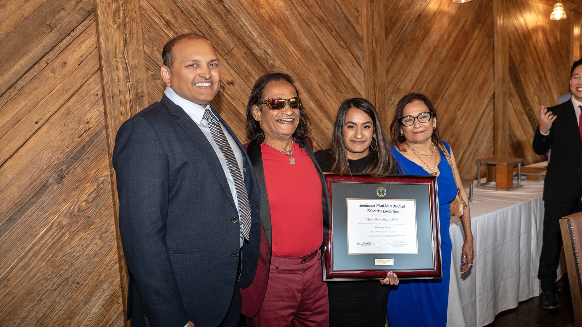 Dr. Sajni Amin with her family holding her fellowship certificate