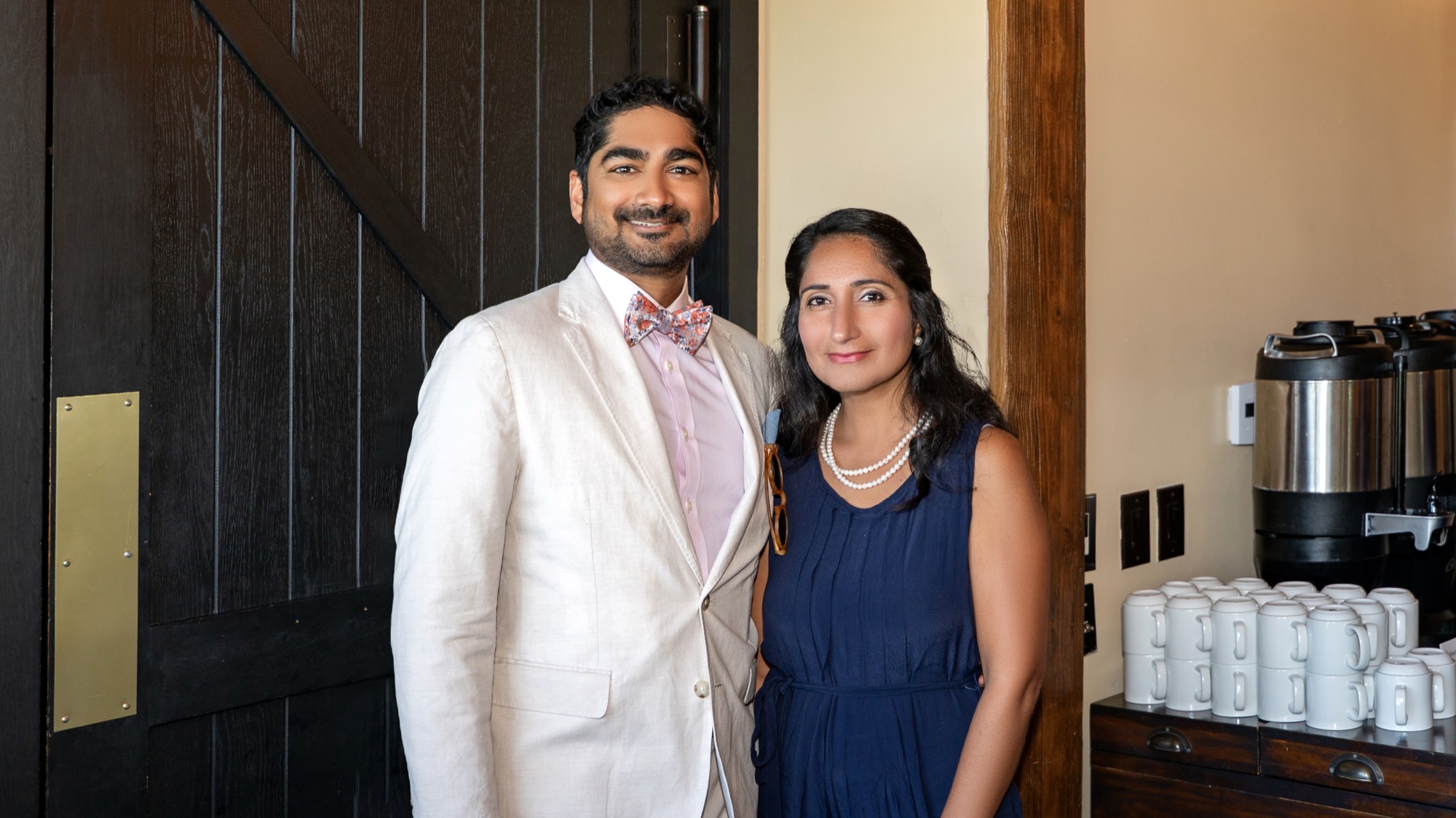 Dr. Amin and her husband posing together at the reception entrance