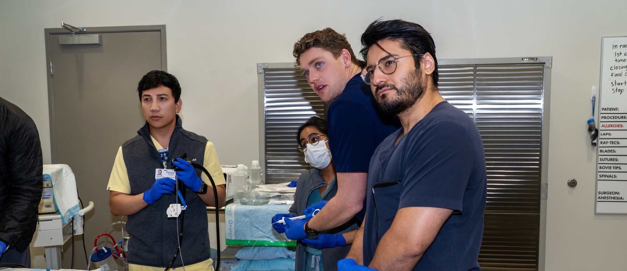 Fellows watching the monitor while working the scope during hands-on training