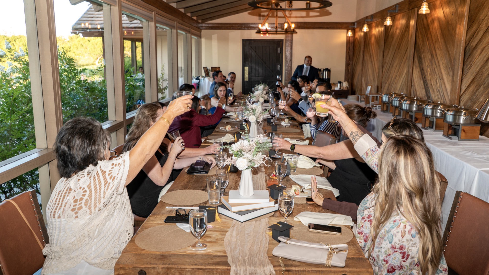 Guests raising a toast around the dinner table
