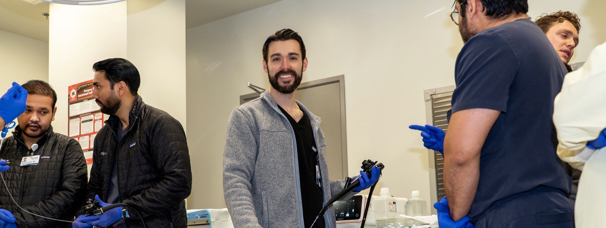 Fellow smiling while holding an endoscope during a training rep