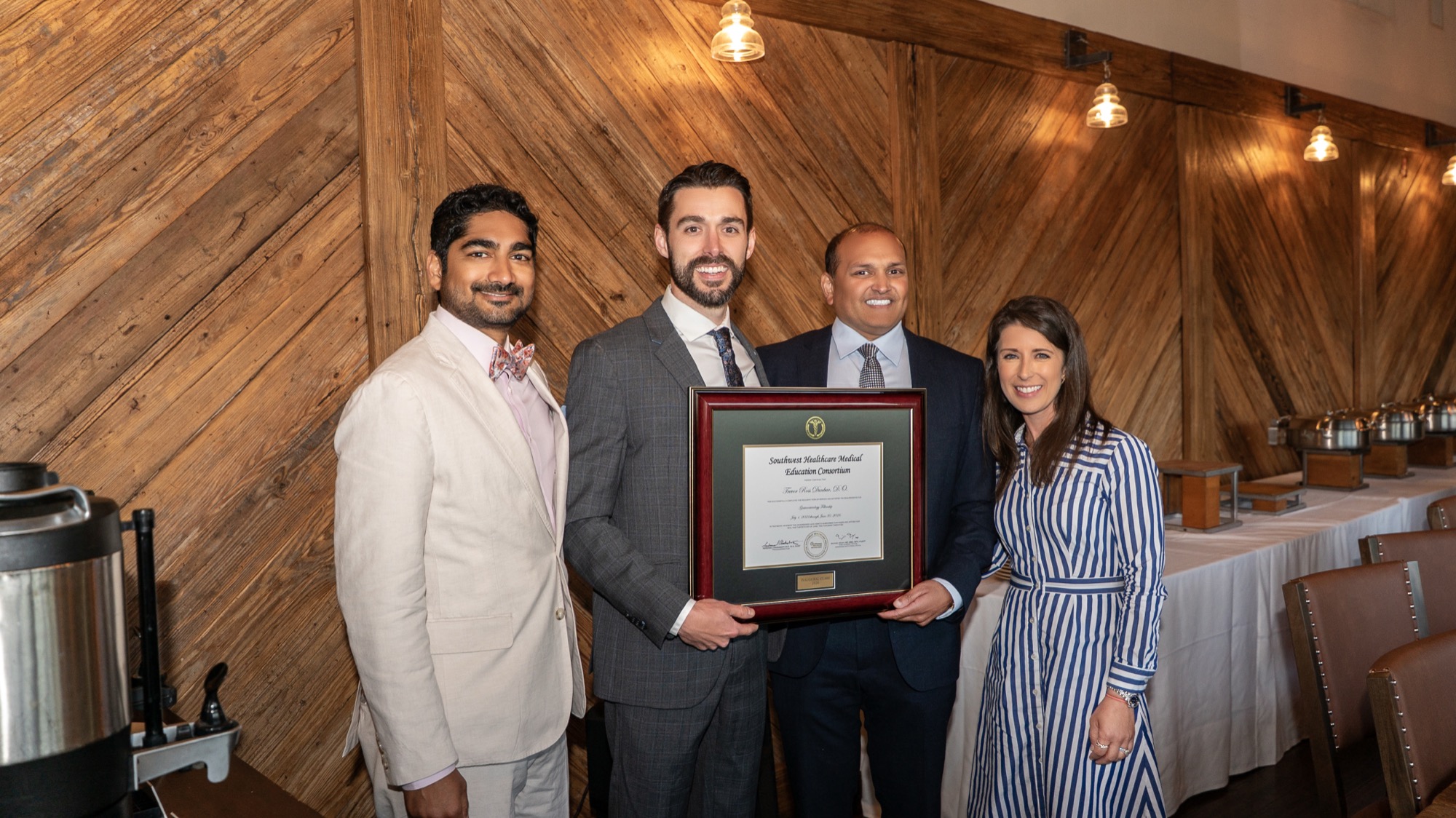 Dr. Trevor Dunbar receiving his fellowship certificate from Dr. Veluvolu