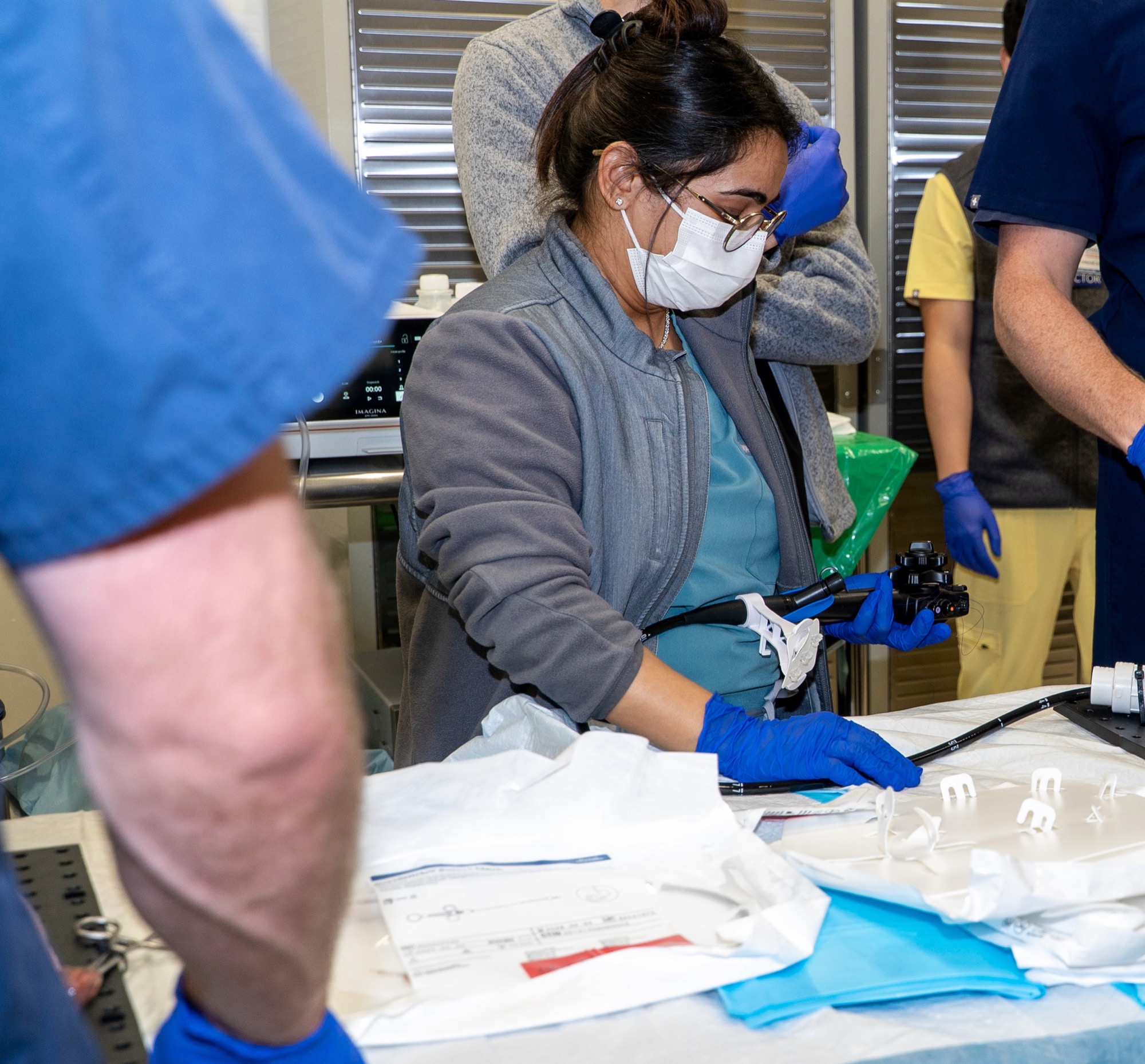 Fellow deploying an endoscopic tool at the training table
