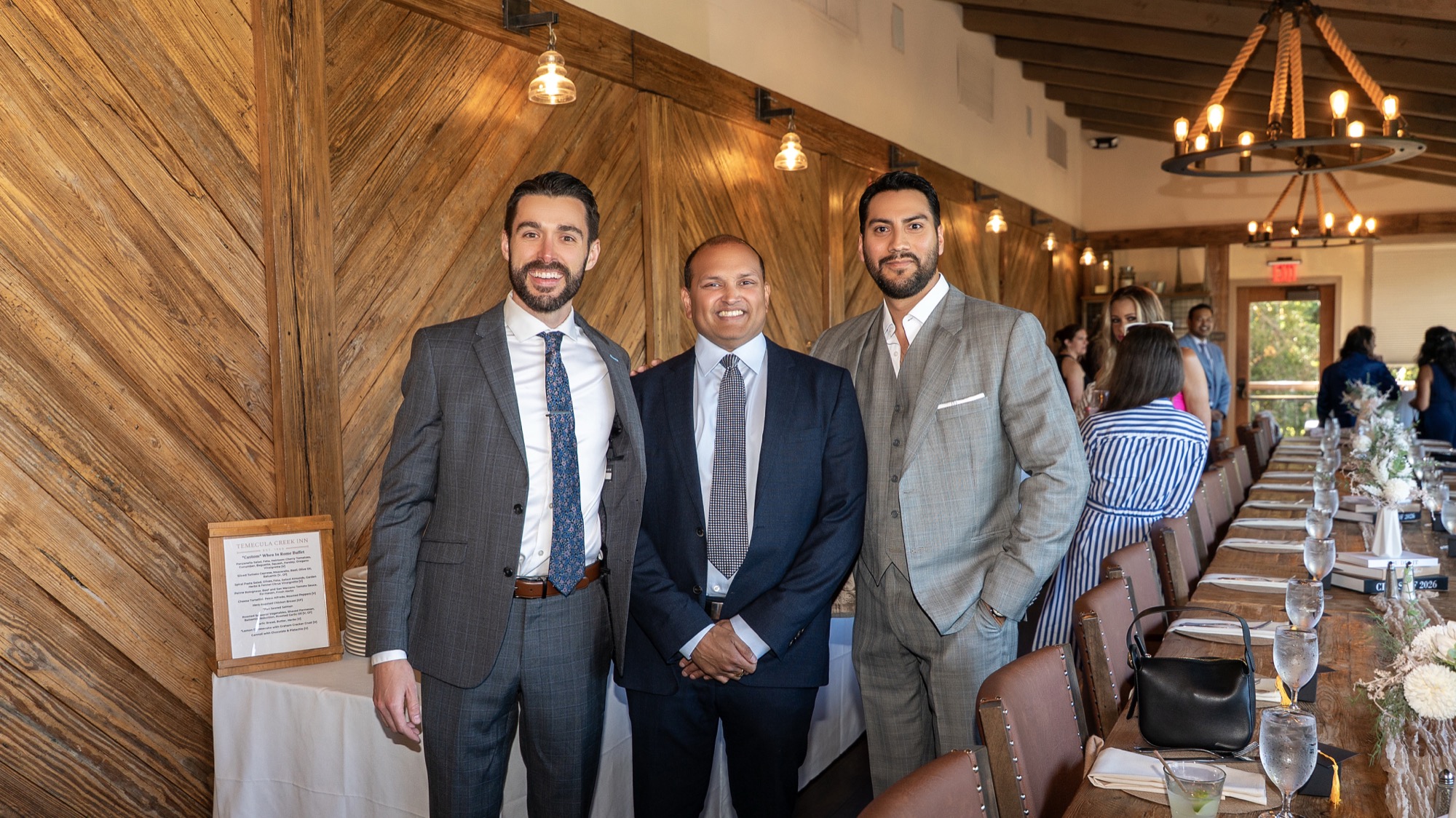 Dr. Trevor Dunbar, Dr. Veluvolu, and a colleague by the dinner table