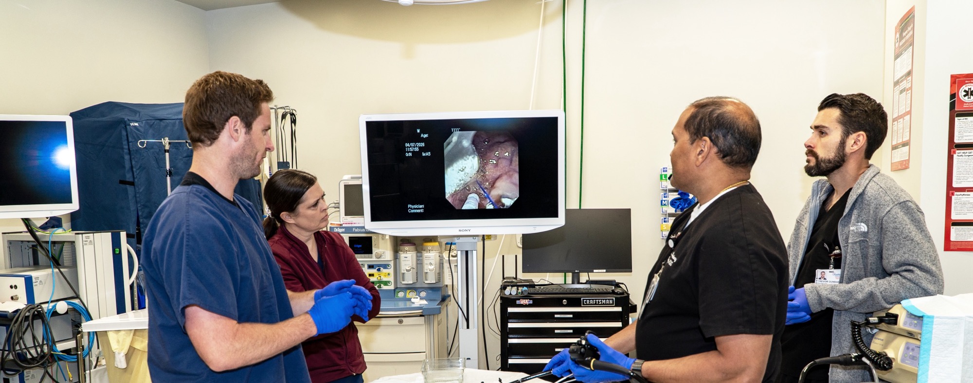 Trinity MSG team and fellows observing a live endoscopy on the monitor together