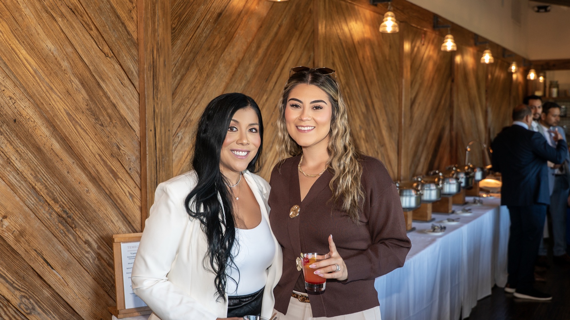 Guests smiling together during cocktail hour